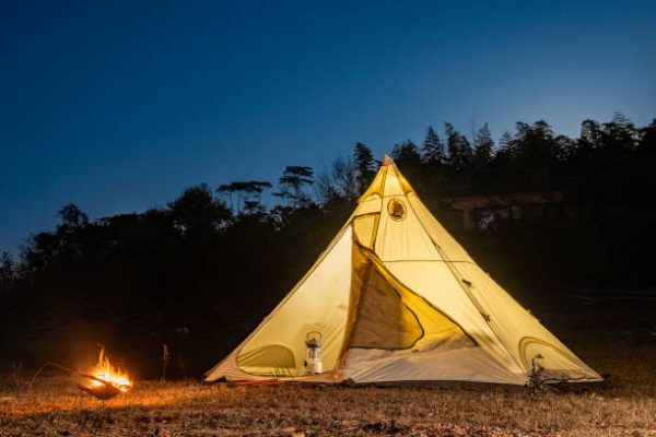 Pyramid tent and bonfire at night